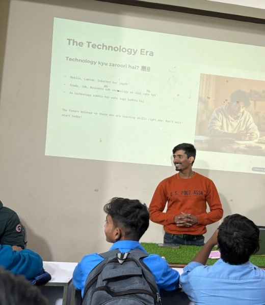 Instructor teaching students in a classroom about technology and digital skills with presentation on screen